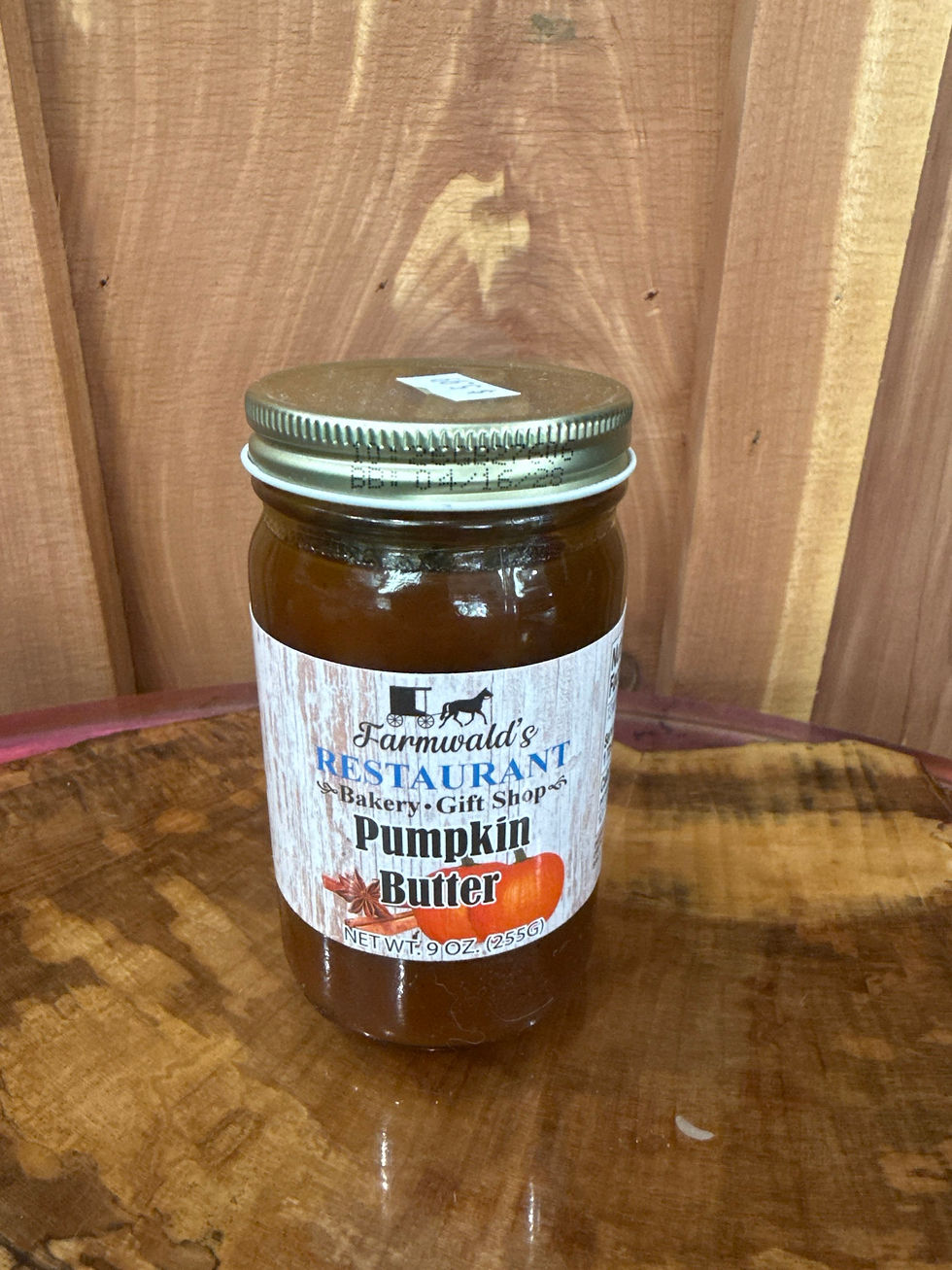 Farmwald's Pumpkin Butter 9oz jar on a wooden surface.