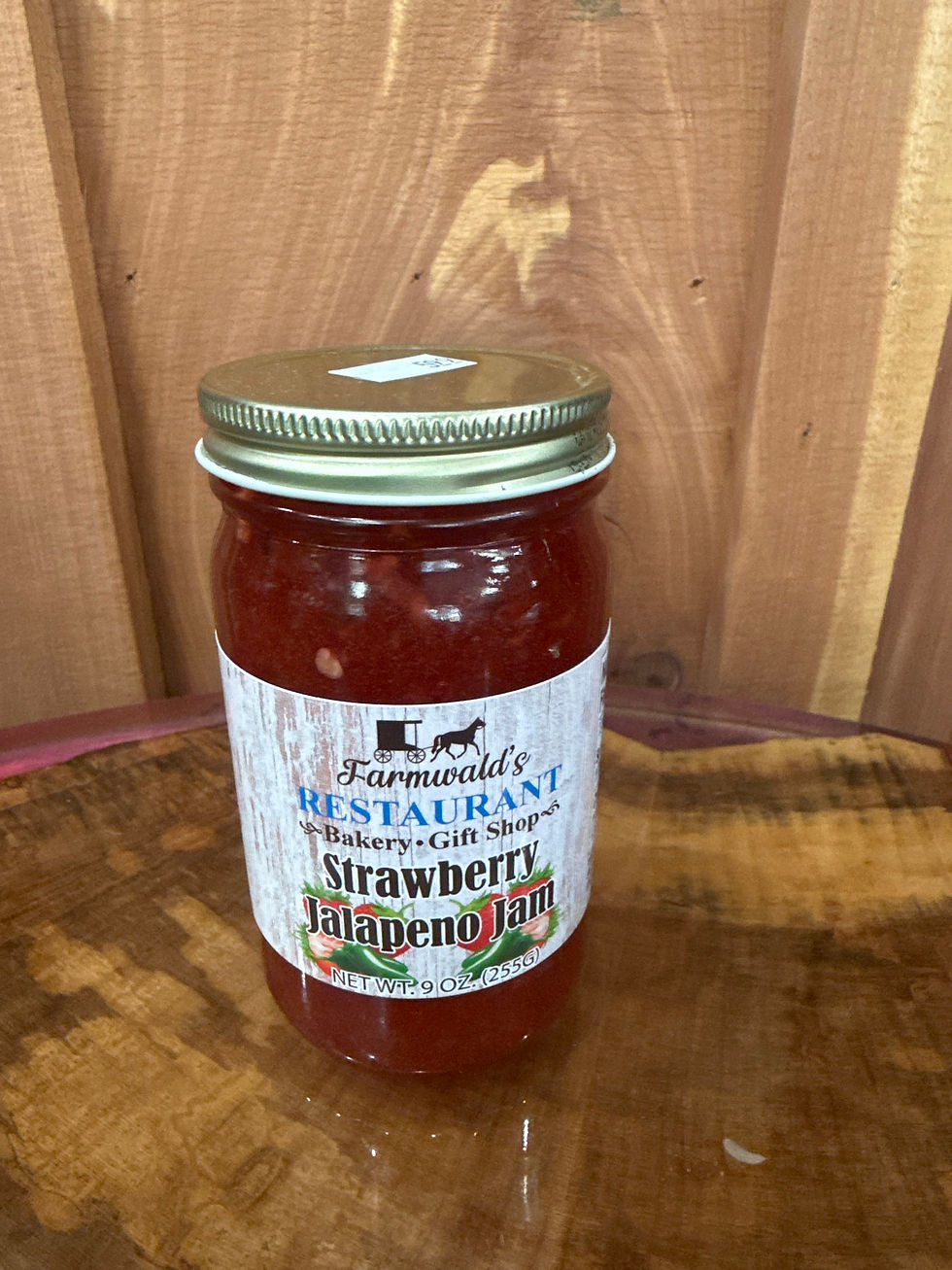 Farmwald's Strawberry Jalapeño Jam 9oz jar on wood.