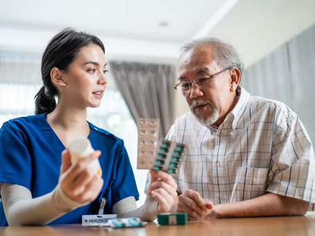 Doctor reviewing medication for elderly patient at home