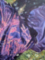 Vibrant purple fabric with shimmering light and small flowers