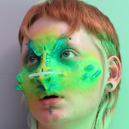 My Alien alter ego someone who looks half alien, half human. They have neon green reptilian features and some pale skin tone.