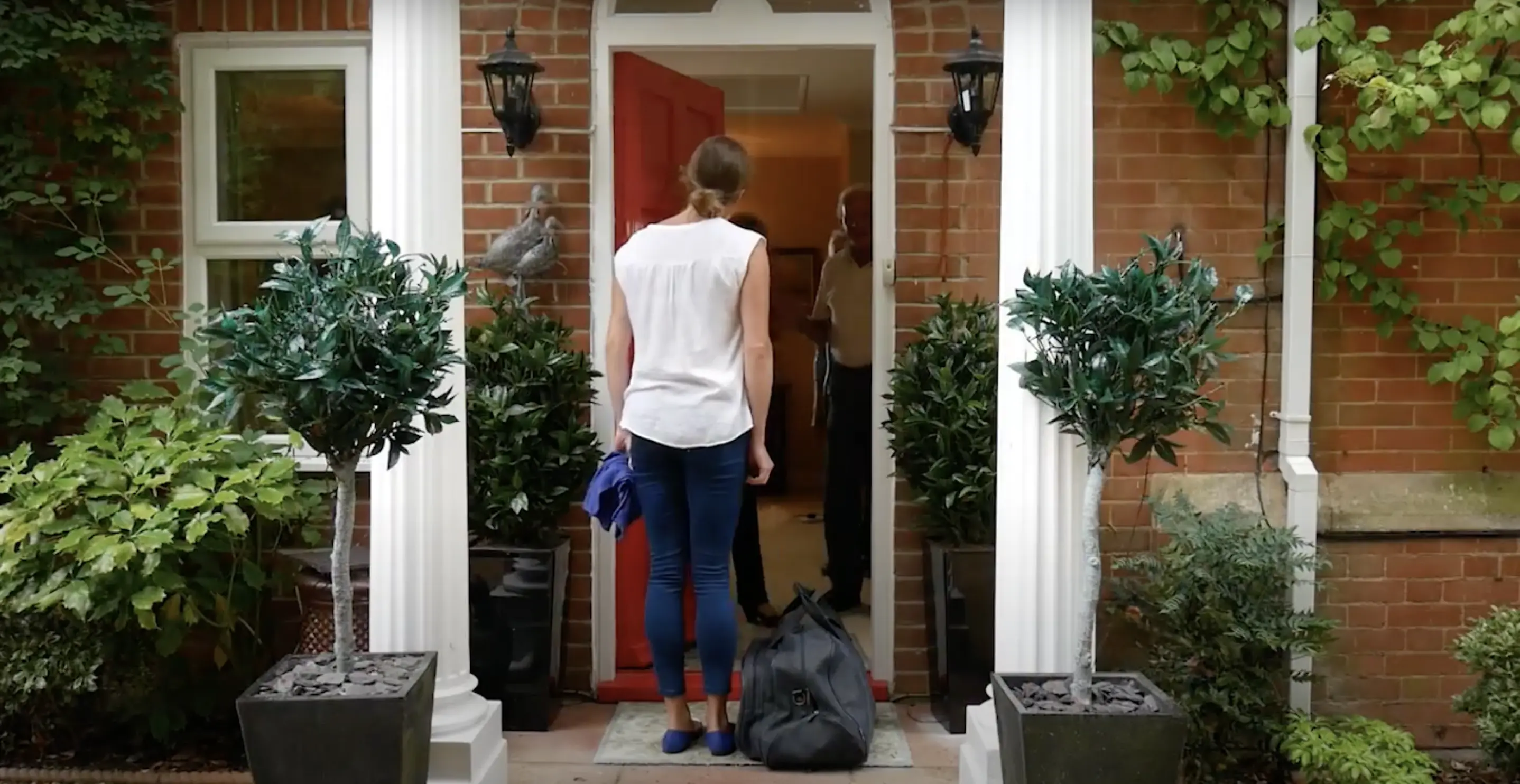 Private carer arriving at front door of elderly client
