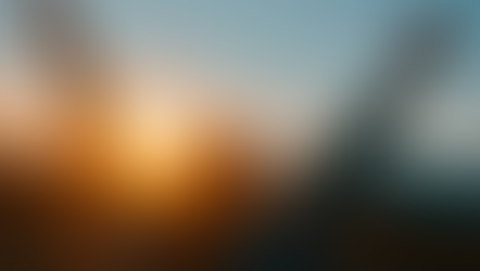 woman with her arms raised at sunrise