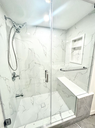 Standing shower with custom bench and built-in niche in a Toronto condo