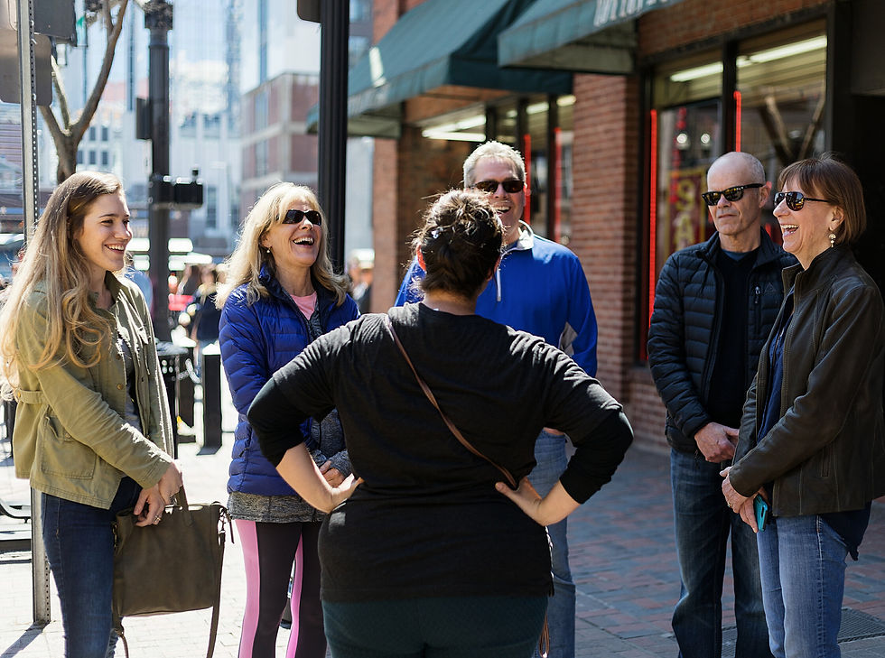 Wide angle view of a yellow NYC tour bus parked near the Statue of Liberty ferry terminal