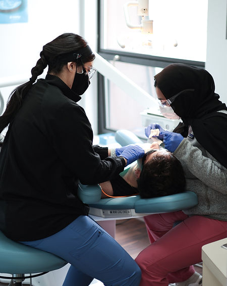 Dr. Anusha Atique treating a patient at Danbury Bright Smiles in Danbury, CT