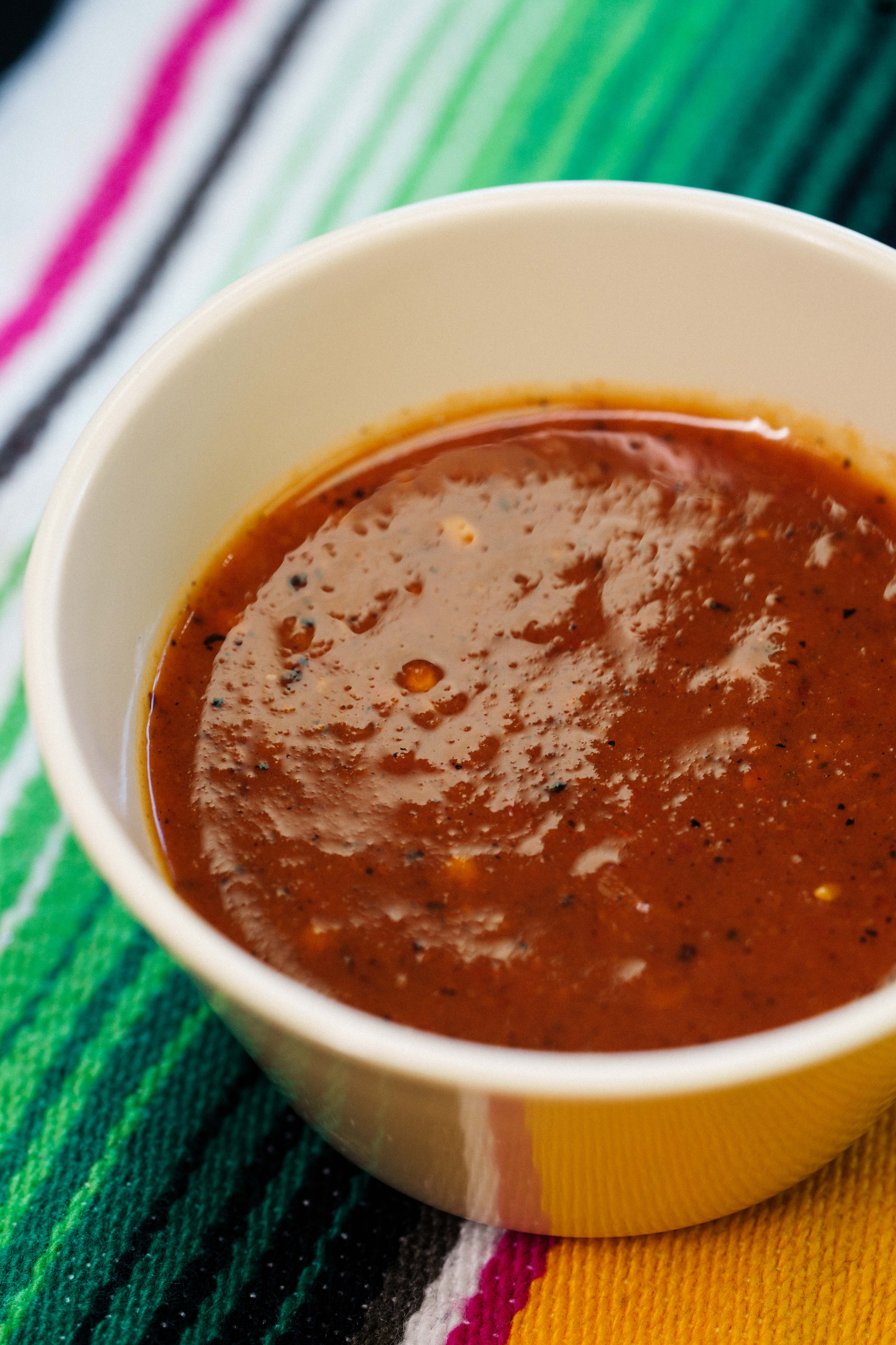 Spoonful of pozole showing hominy and pork