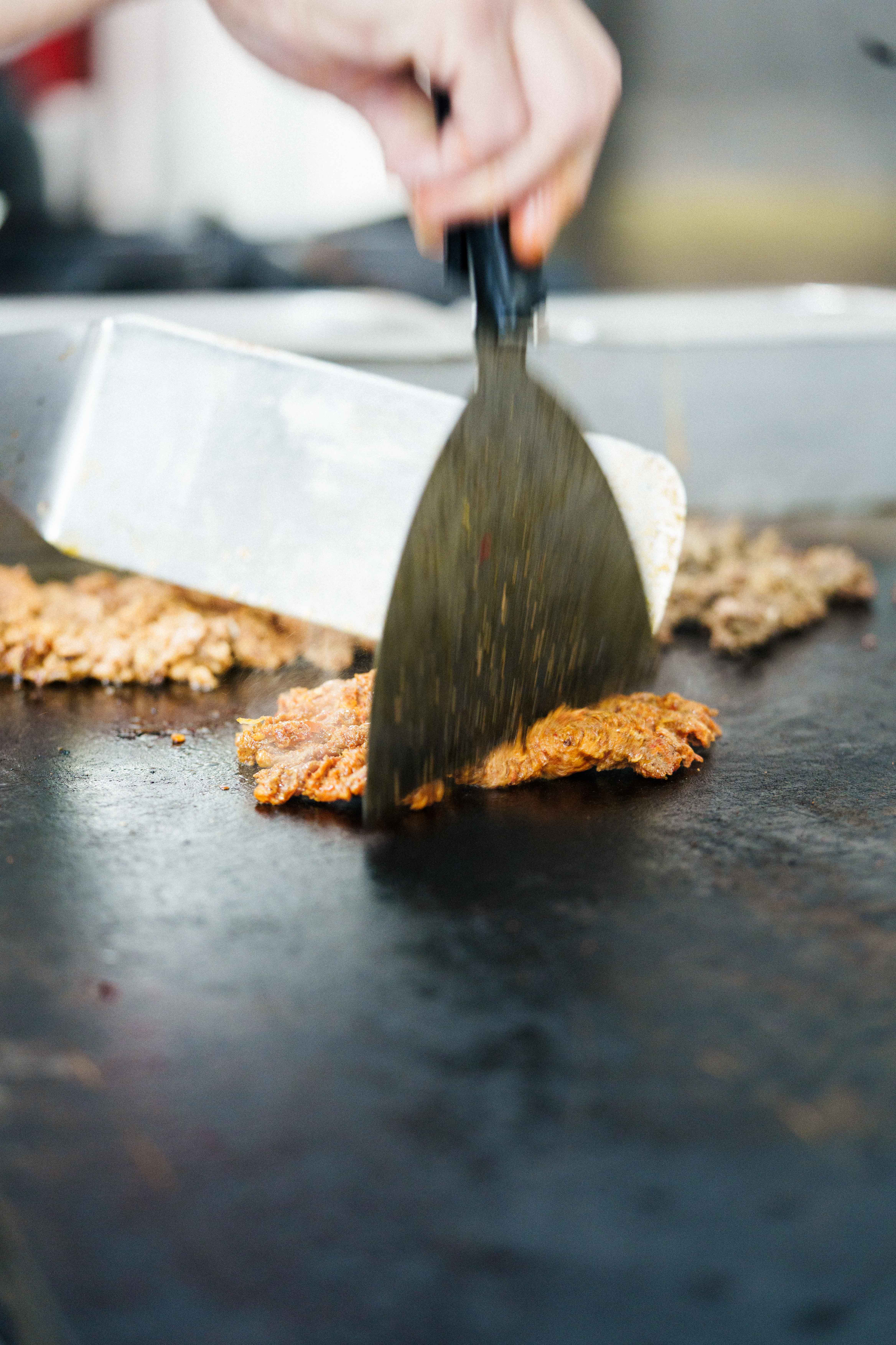 Steak being chopped on the grill
