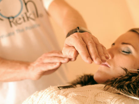 Women relaxing enjoing a healing Reiki session