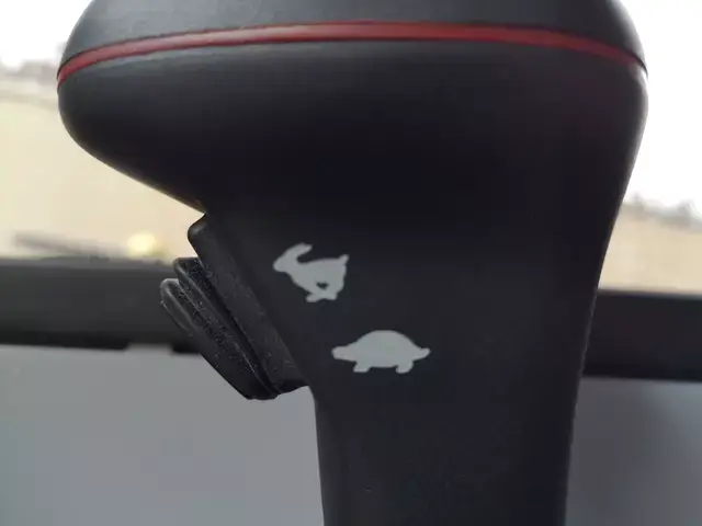 Thumbnail: Detailed view of the excavator control switches and throttle lever inside the heated cabin.