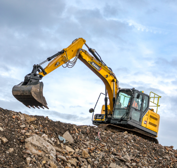 Thumbnail: SANY SY135 conventional tail swing excavator loading material on restricted site footprint