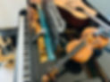 Violin, guitar and microphone on top of a bechstein grand piano.