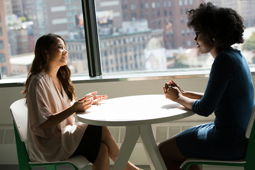 Eye-level view of a person writing notes during a calm conversation
