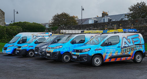 Fleet of branded blue electrician vans parked together in commercial yard