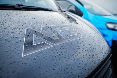 Close-up of ATS Electrics logo embossed on bonnet of blue service van