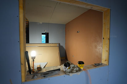 Domestic room undergoing full electrical rewiring work and wall prep