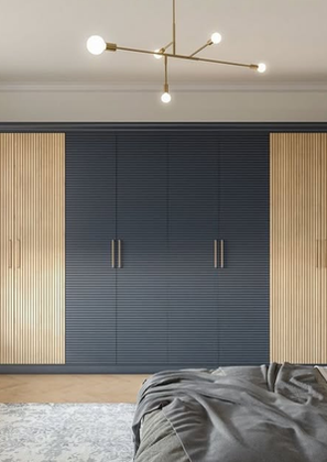 Contemporary bedroom wardrobe with a mix of dark blue and light wood panels