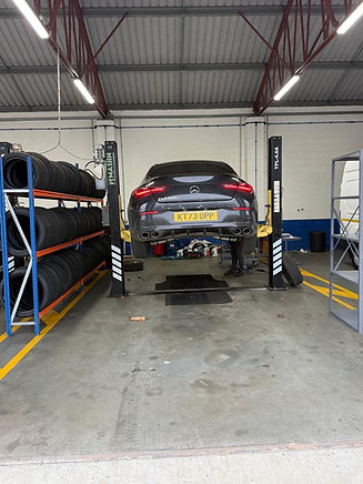 Servicing of a black car with lifting up of car