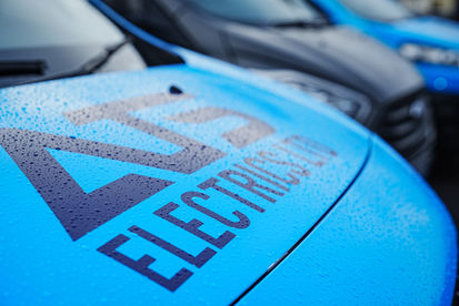 Close-up of ATS Electrics company lettering printed on blue van bonnet