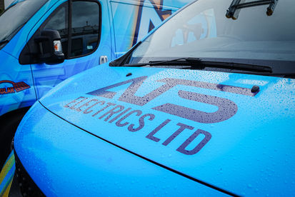 Close-up of ATS Electrics Ltd logo printed on bonnet of blue company vehicle