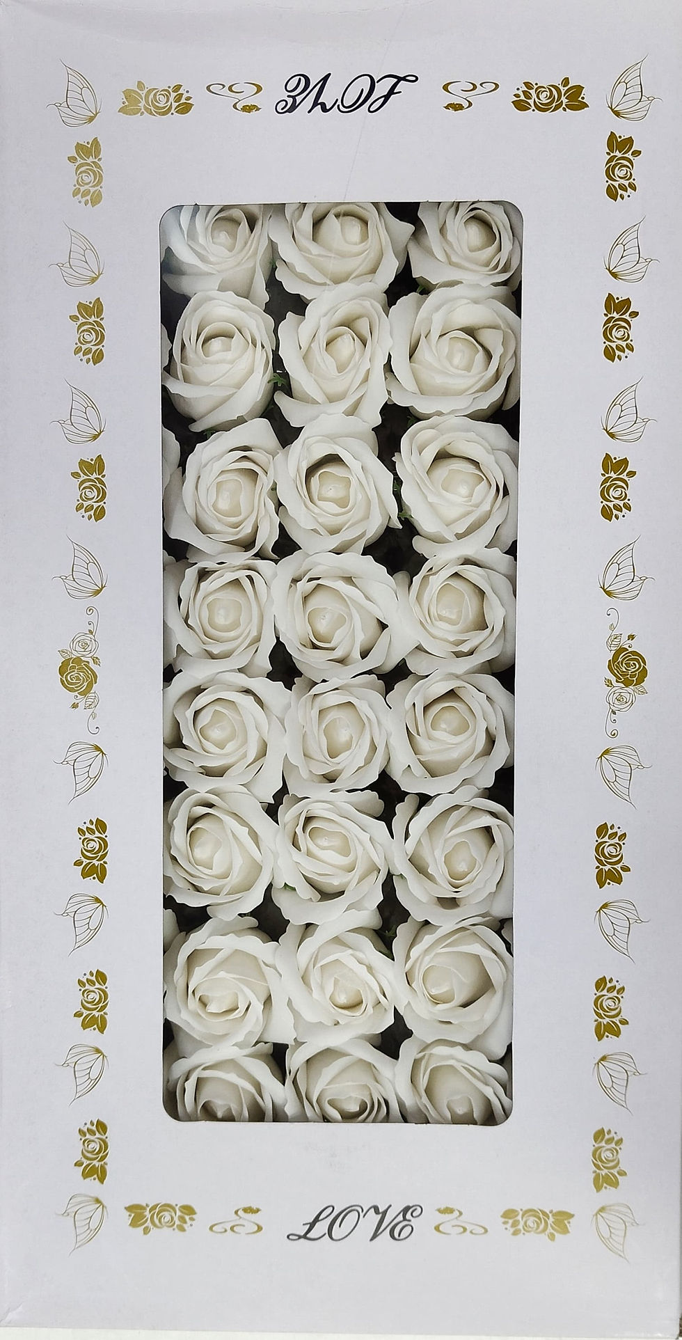 A square white box with golden decorative accents on the sides contains 16 delicate white artificial roses.