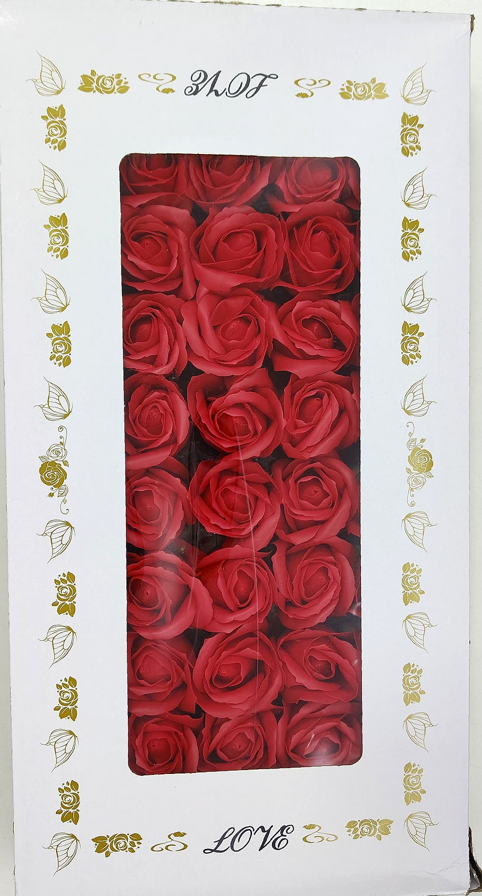 A square white box with golden decorative accents on the sides contains 16 vibrant red artificial roses.