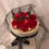 Thumbnail: A birthday cake with red roses, topped with a small, glowing crown, wrapped in black mesh.
