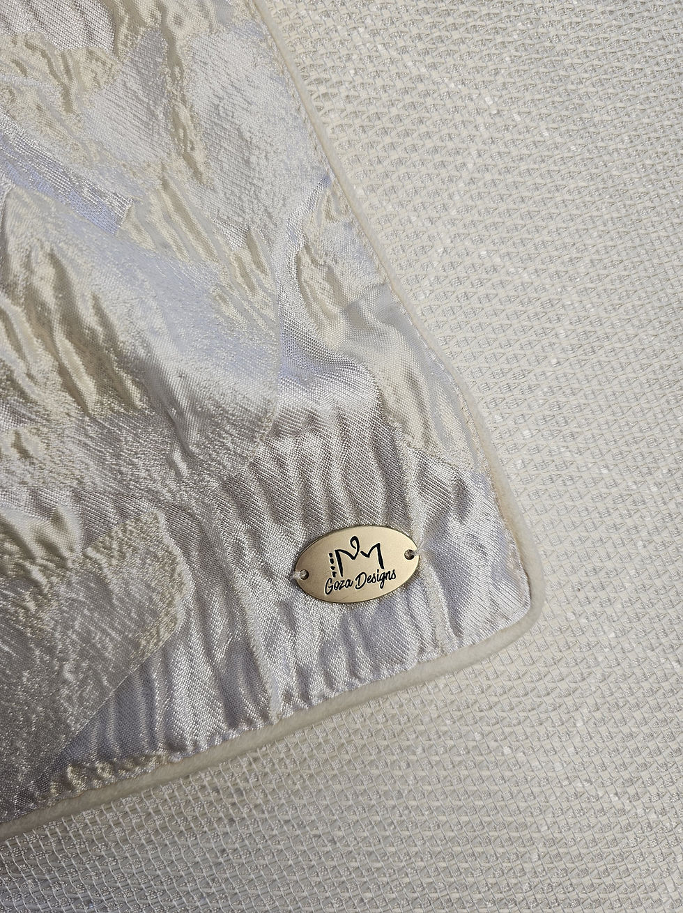 Thumbnail: Crinkled white fabric with a metallic brand tag