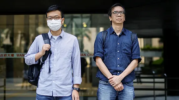 Chung Pui-kuen, former editor-in-chief of the now-shuttered Stand News, and Patrick Lam, former acting editor, leave court on June 27, 2023 after a hearing on charges of conspiring to publish seditious publications in Hong Kong. Tyrone Siu/Reuters