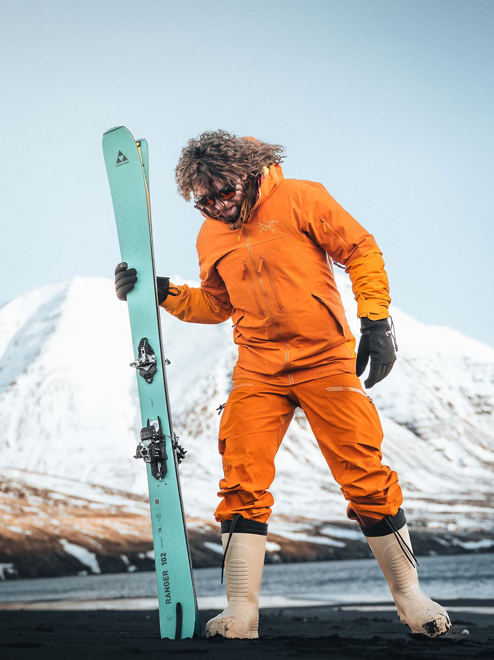 A skier in orange clothing in the mountains