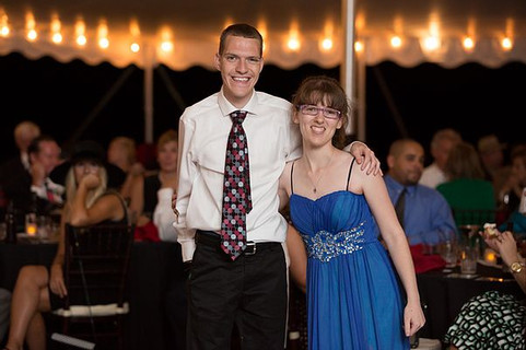 Image of Adam Shipp and Pam Roberts posing under the lighted tent. 