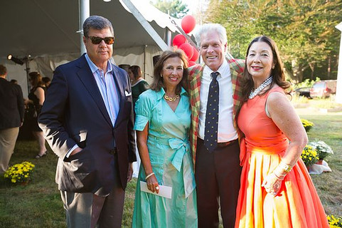 Image of four partygoers posing outside at the Mad Men gala. 