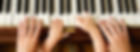 Closeup on hands of toddler and mother playing piano together
