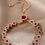 Thumbnail: Elegant Red Crystal Floral Bracelet - Adjustable Rose Gold Chain