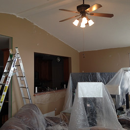 An interior painting project for a living room is underway