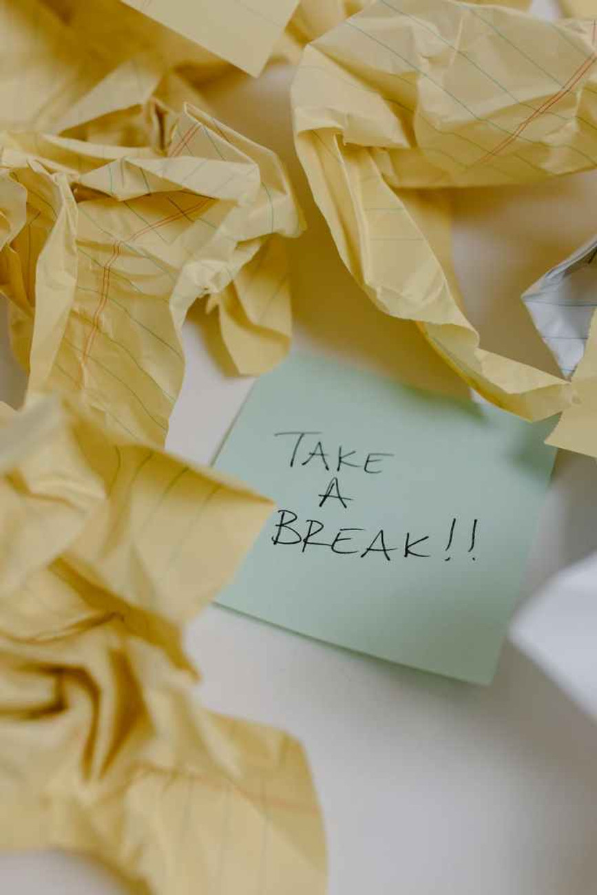 texta sticky note around crumpled yellow papers