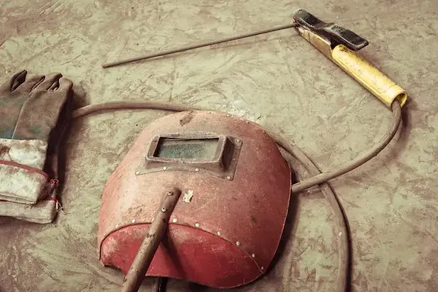 electric-welding-machine-electric-wire-masks-gloves-tongs-are-very-old_1359-3173.webp