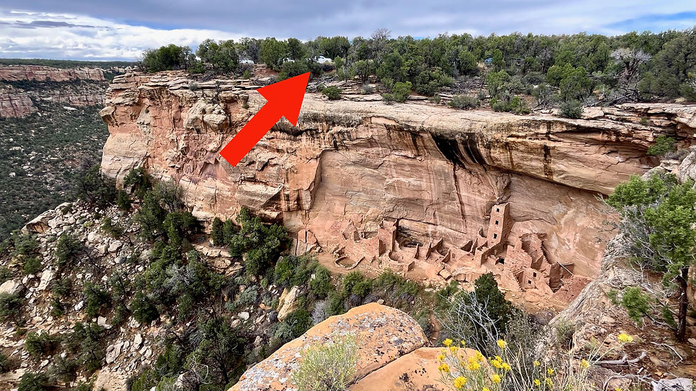 The red arrow indicates the location of our truck for scale on the top of the mesa above Square Tower House.