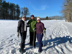 Jonna Dijkstra and 2 female friends in ski apparel on top of a snowy mountain.