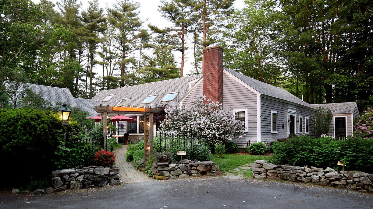 Exterior view of the Morning Glory Inn with summer gardens in full bloom.