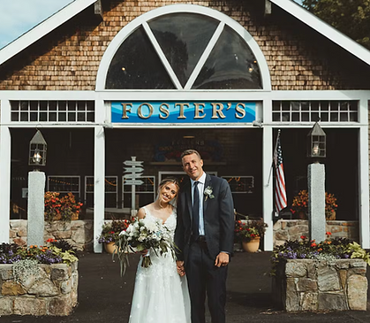 just married couple in front of fosters clambakes front entrance