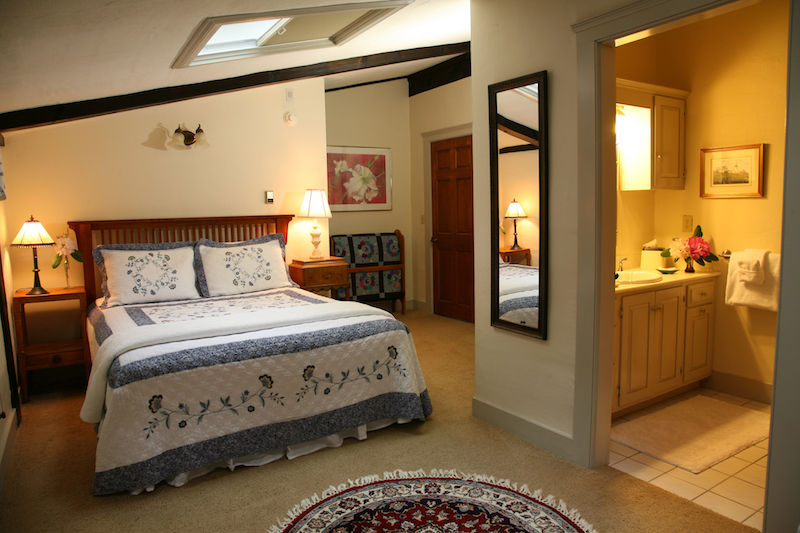 The interior of the cozy Sandpiper Room at the Morning Glory Inn bed and breakfast in York, Maine shows the traditional New England quilt on the queen sized bed.