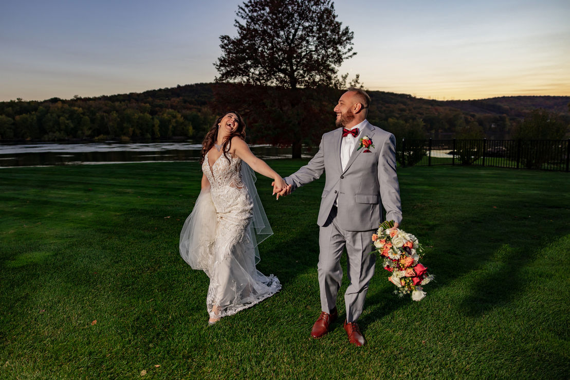Bride and groom hold hands and walk
