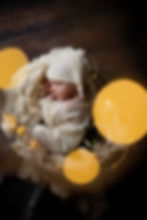 Newborn baby sleeping in white outfit