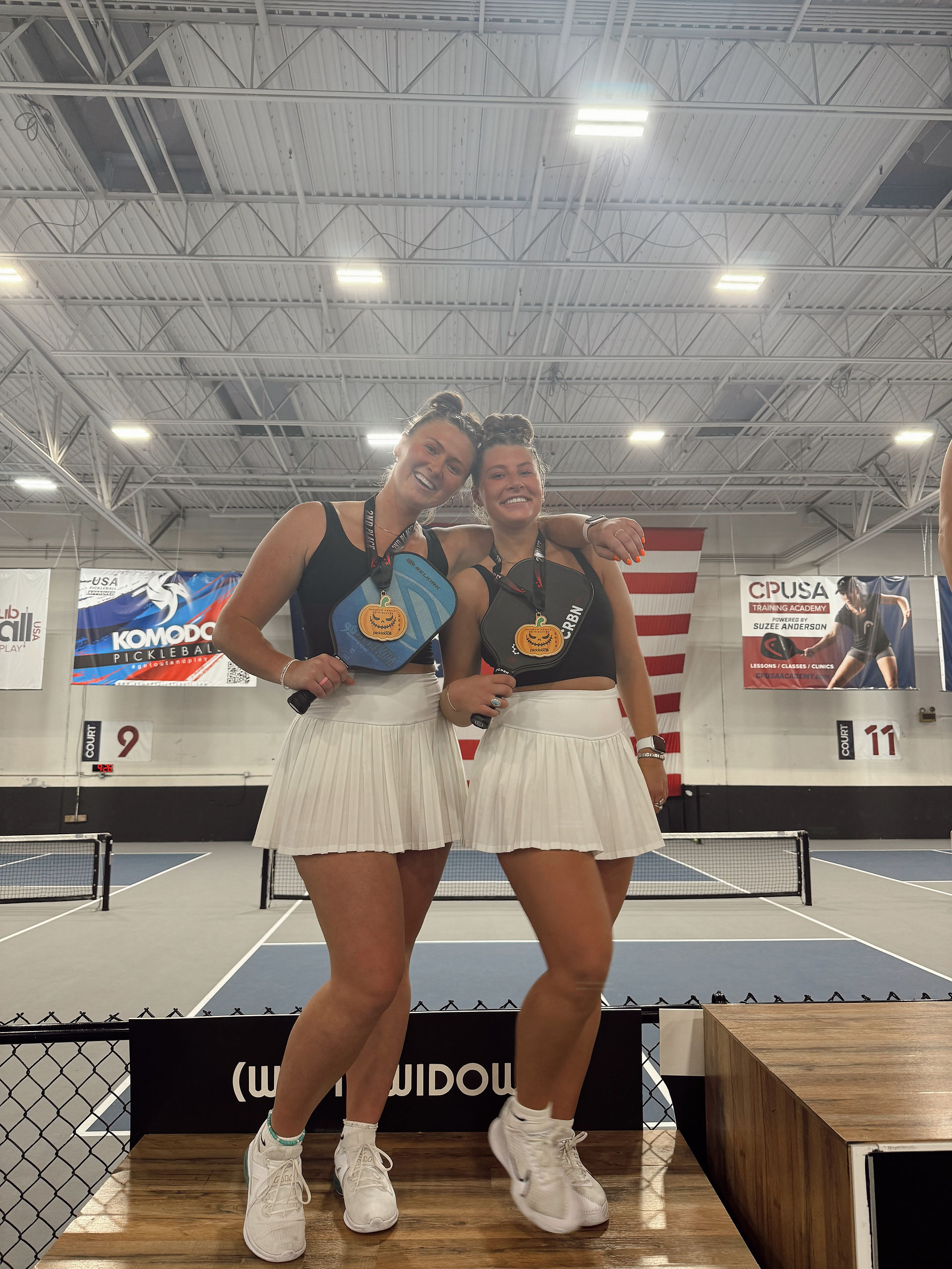 Miss Sage got a medal playing pickleball with a friend
