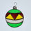 Thumbnail: A Christmas tree ornament in green, gold, red and white stained glass hanging in a window.