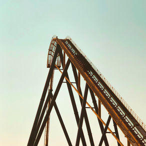 A rollercoaster going up on the climb at the beginning.