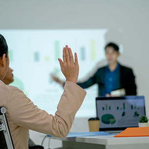 women raises her hand to ask a question