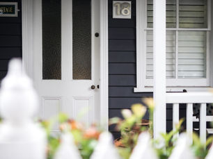 front door and window of weather board home