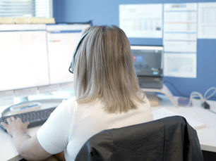 Member of our customer care team at their desk